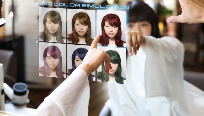 Woman touch selecting a picture of herself on a digital screen