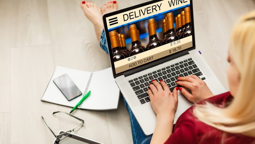 Woman laptop with app delivery food wine screen
